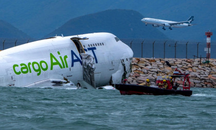 Cargo plane skids off Hong Kong runway, killing 2 people