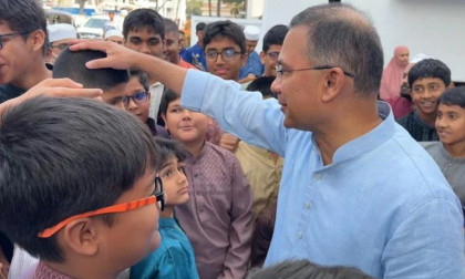 Tarique Rahman greets children after Friday prayers