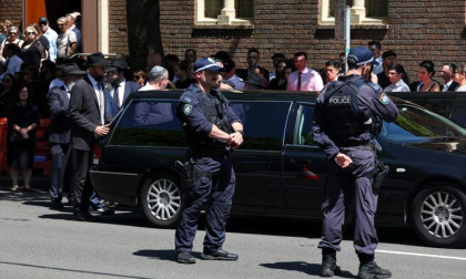 Gunman fires on Sydney funeral venue, police hunt suspect